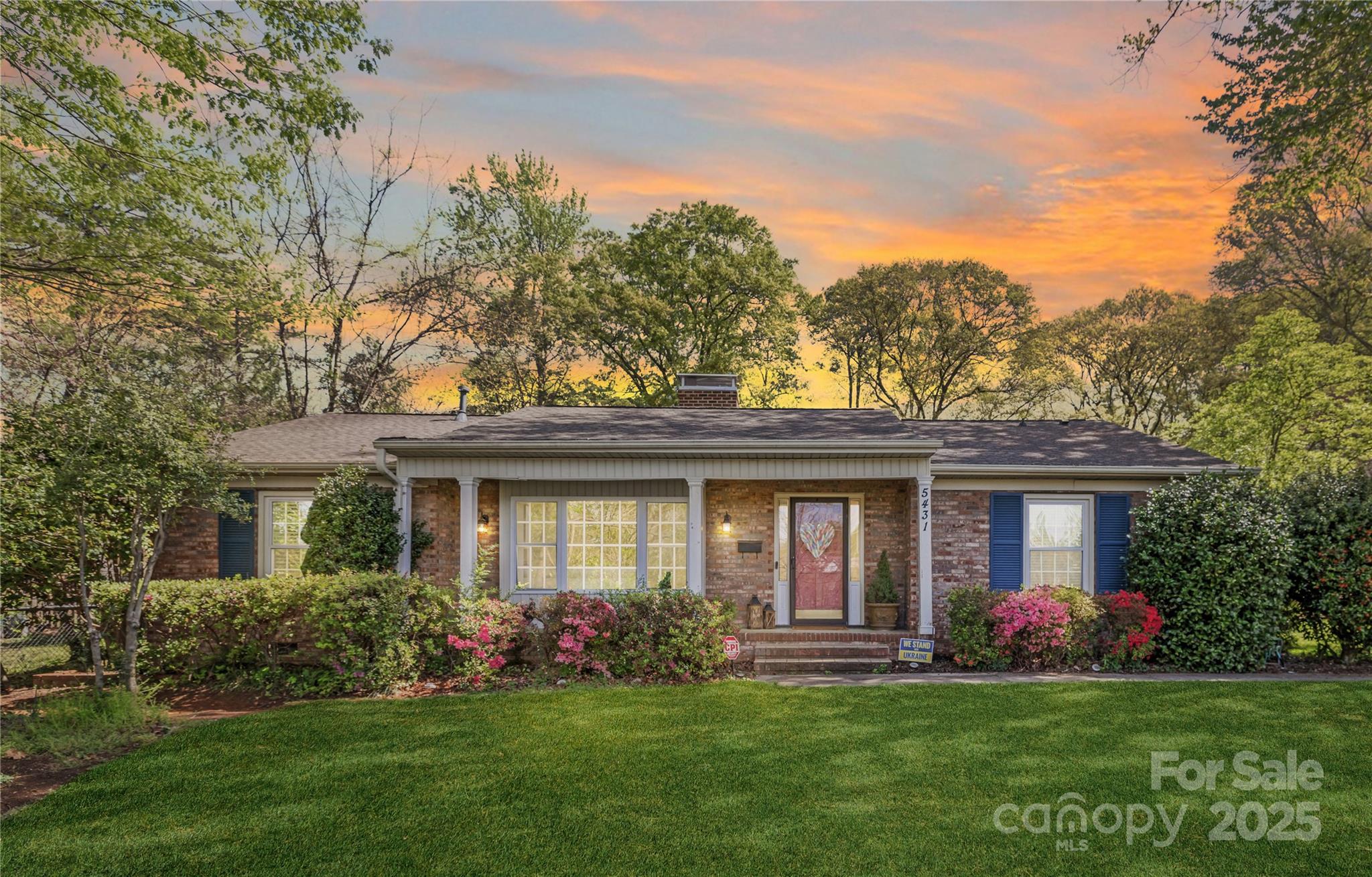 5431 Park Road Charlotte, NC 28209 - Photo 1 of 26 a front view of a house with a garden and trees
