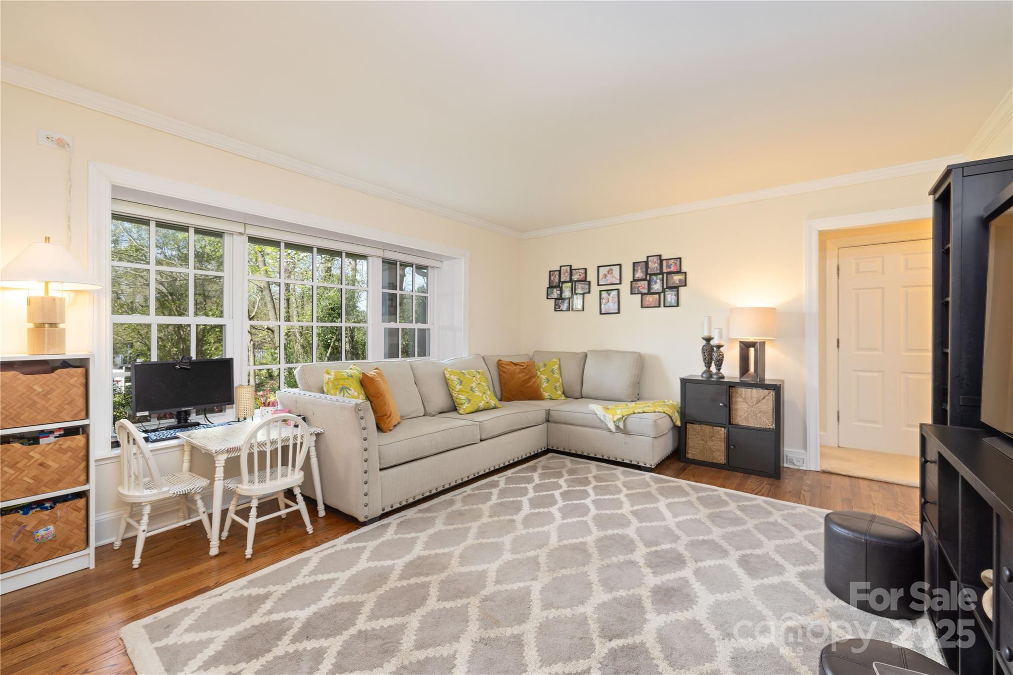 5431 Park Road Charlotte, NC 28209 - Photo 11 of 26 a living room with furniture a flat screen tv and a table