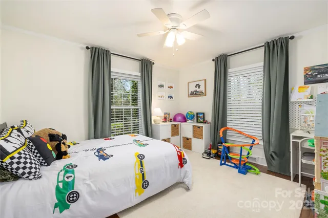 a bedroom that has a bed and a chandelier