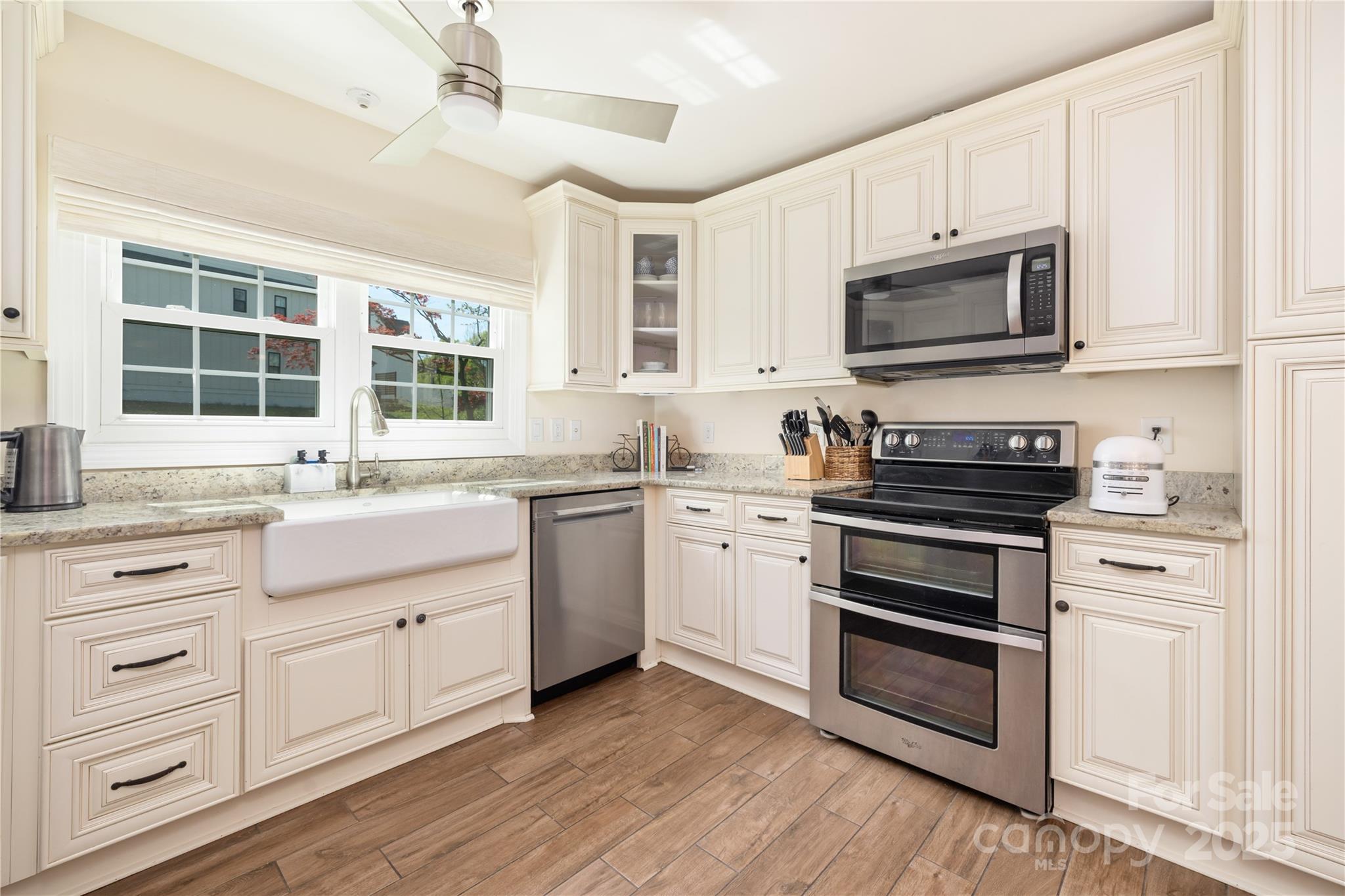 5431 Park Road Charlotte, NC 28209 - Photo 4 of 26 a kitchen with white cabinets stainless steel appliances and sink