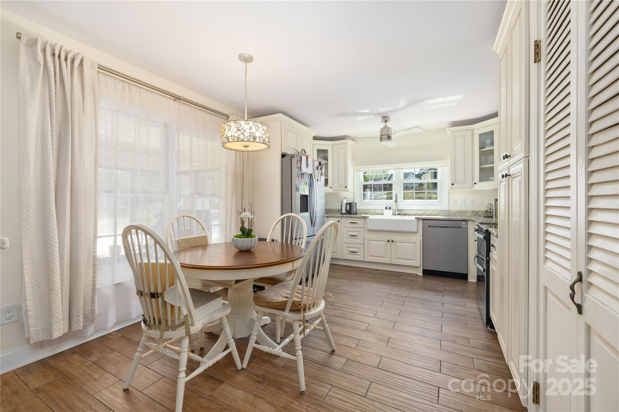5431 Park Road Charlotte, NC 28209 - Photo 6 of 26 a view of a dining room and livingroom with furniture wooden floor a chandelier
