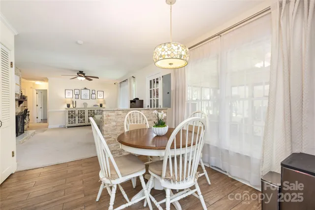 a view of a dining room with furniture wooden floor and chandelier