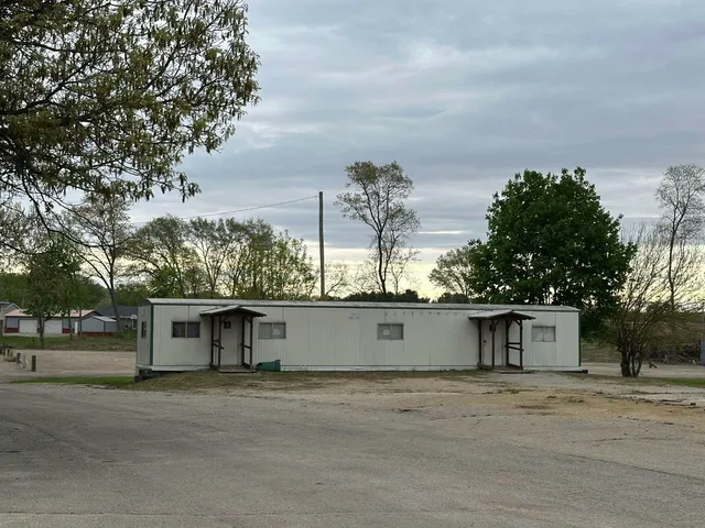 a view of a house with a yard and a tree