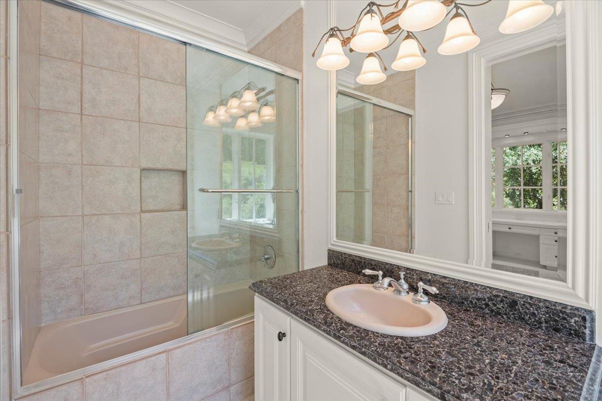 14113 Pike Road Saratoga, CA 95070 - Photo 33 of 78 a bathroom with a granite countertop sink a mirror and a shower