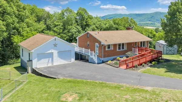 a aerial view of a house with a yard and sitting area