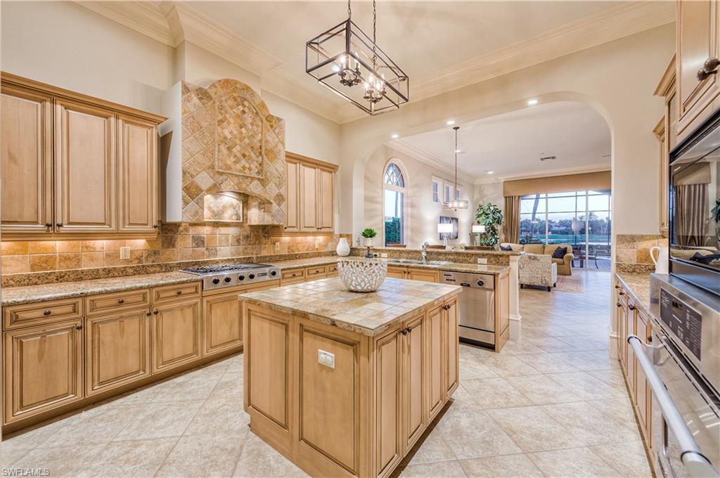 2829 Capistrano Way Naples, FL 34105 - Photo 13 of 35 a kitchen with counter top space appliances and cabinets