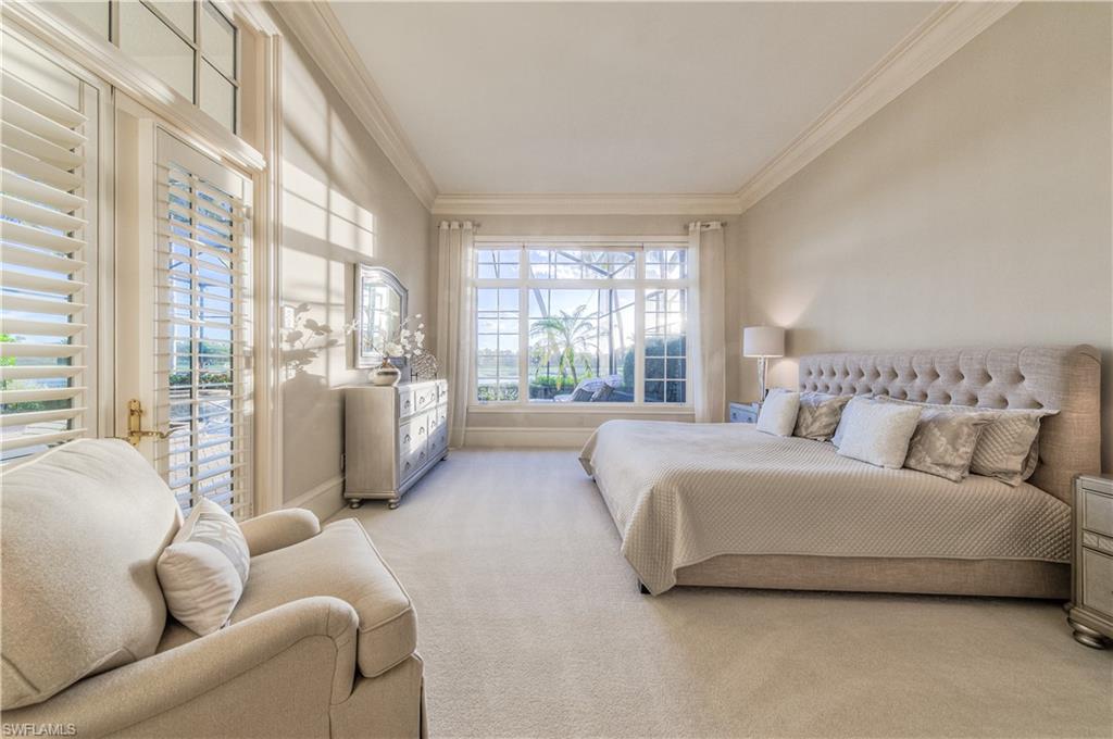 2829 Capistrano Way Naples, FL 34105 - Photo 16 of 35 a spacious bedroom with a bed couch and a large window
