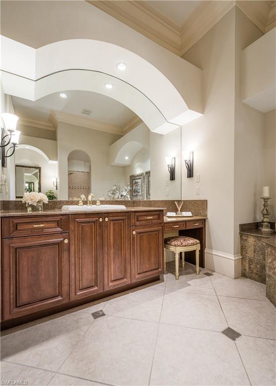 2829 Capistrano Way Naples, FL 34105 - Photo 19 of 35 a bathroom with a sink and a mirror