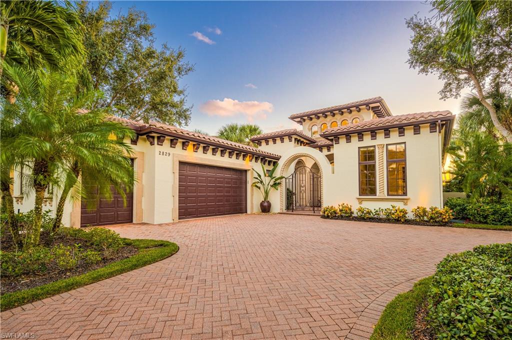 2829 Capistrano Way Naples, FL 34105 - Photo 2 of 35 a front view of a house with a yard and garage