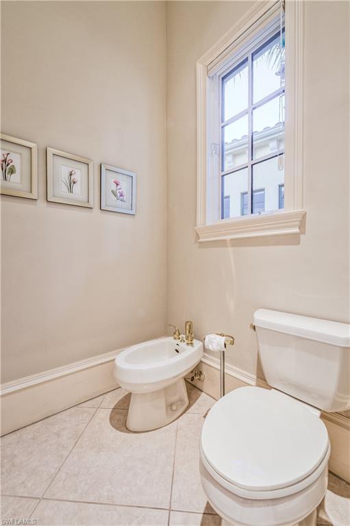 2829 Capistrano Way Naples, FL 34105 - Photo 21 of 35 a white toilet sitting next to a bathroom sink