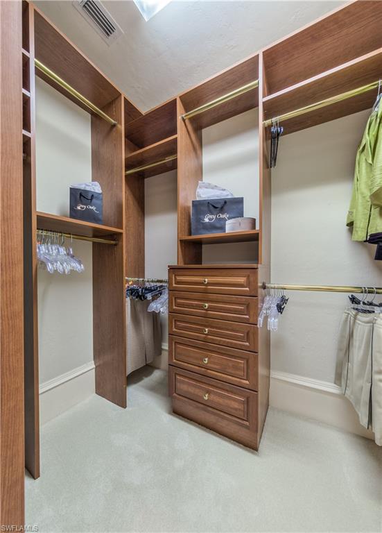2829 Capistrano Way Naples, FL 34105 - Photo 22 of 35 a view of walk in closet with clothes and shoes