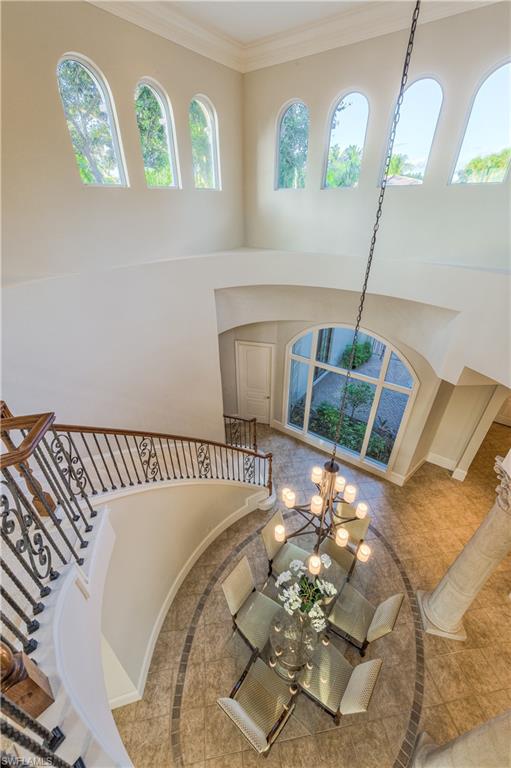 2829 Capistrano Way Naples, FL 34105 - Photo 27 of 35 a bed sitting in a bedroom next to a window