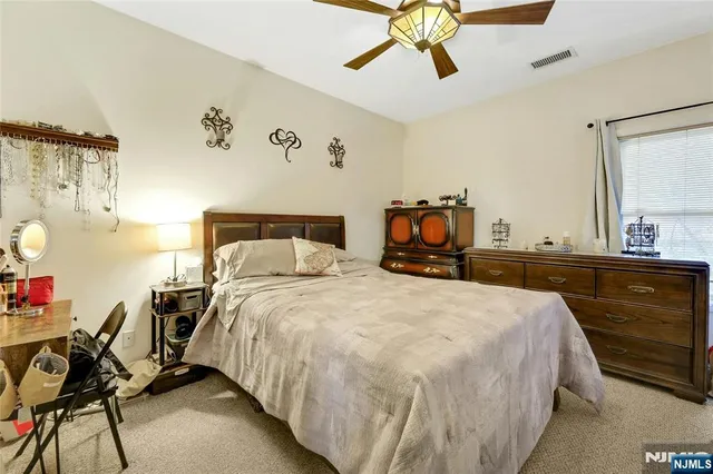 a bed room with a bed and dresser