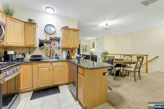 a kitchen with stainless steel appliances granite countertop a sink and cabinets