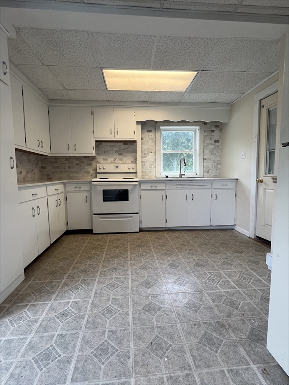 20 Sherwin Street, Unit A Ware, MA 01082 - Photo 2 of 10 a kitchen with granite countertop a stove a sink and a refrigerator