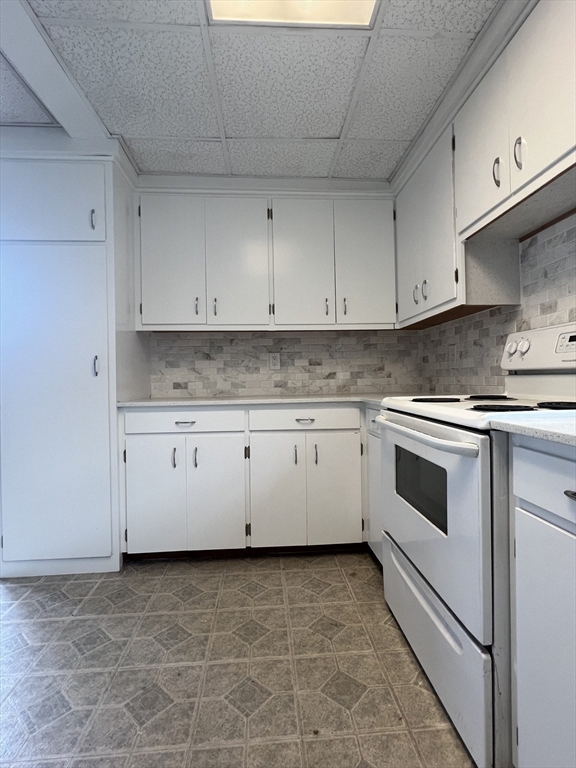20 Sherwin Street, Unit A Ware, MA 01082 - Photo 3 of 10 a white kitchen with granite countertop white cabinets and white appliances