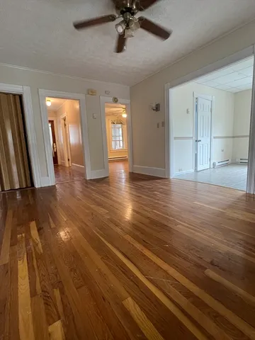 a view of a room with wooden floor and window