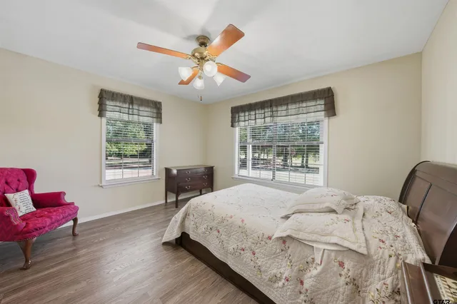 a bedroom with a bed and wooden floor
