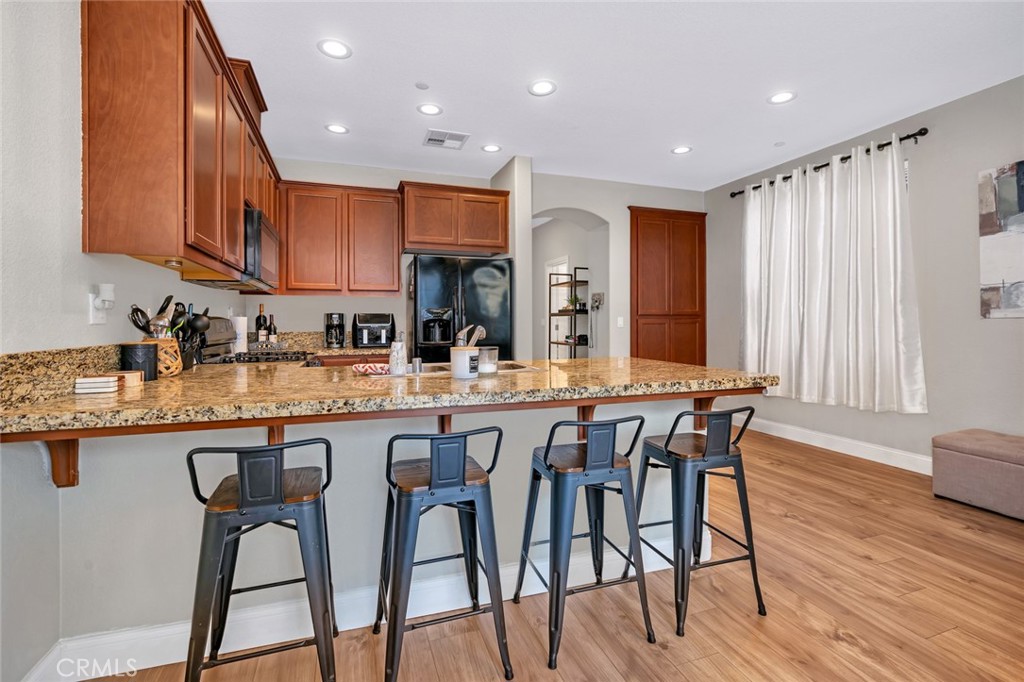 2936 Dillon Lane Merced, CA 95348 - Photo 12 of 34 a kitchen with stainless steel appliances granite countertop table chairs sink and cabinets