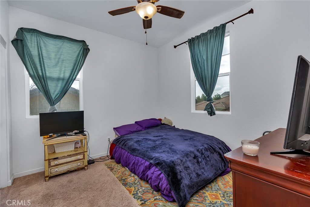 2936 Dillon Lane Merced, CA 95348 - Photo 17 of 34 a bedroom with a bed window and a flat screen tv