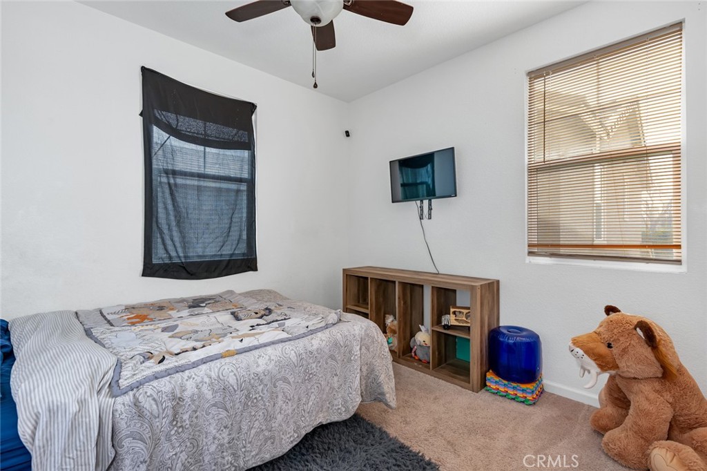 2936 Dillon Lane Merced, CA 95348 - Photo 20 of 34 a bedroom with a bed and a window