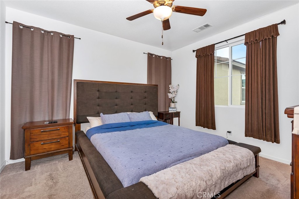 2936 Dillon Lane Merced, CA 95348 - Photo 23 of 34 a bedroom with a bed and a chandelier