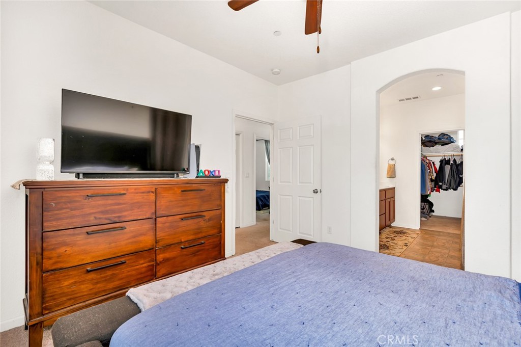 2936 Dillon Lane Merced, CA 95348 - Photo 24 of 34 a bedroom with a bed and flat screen tv