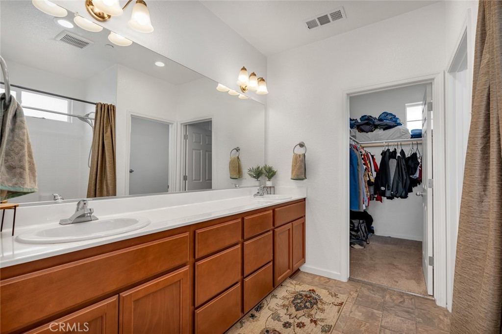 2936 Dillon Lane Merced, CA 95348 - Photo 25 of 34 a bathroom with a sink double vanity and a mirror