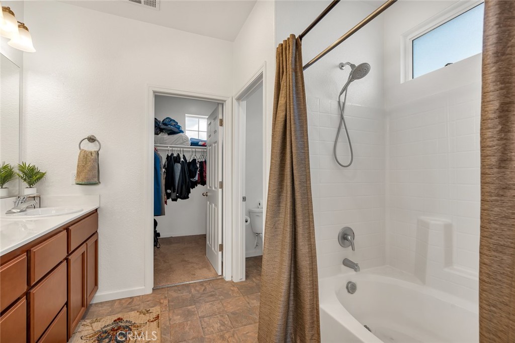 2936 Dillon Lane Merced, CA 95348 - Photo 26 of 34 a bathroom with a tub sink a mirror and shower
