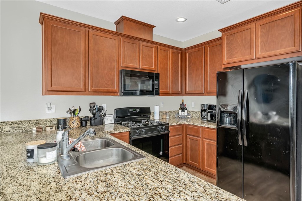 2936 Dillon Lane Merced, CA 95348 - Photo 7 of 34 a kitchen with kitchen island granite countertop a sink stove and cabinets