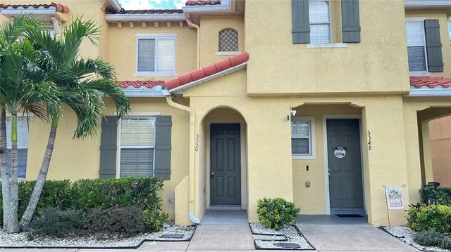 a car parked in front of a white house