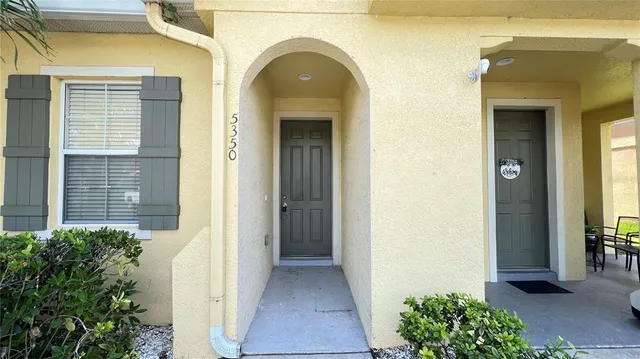 a view of a hallway with wooden floor and closet area