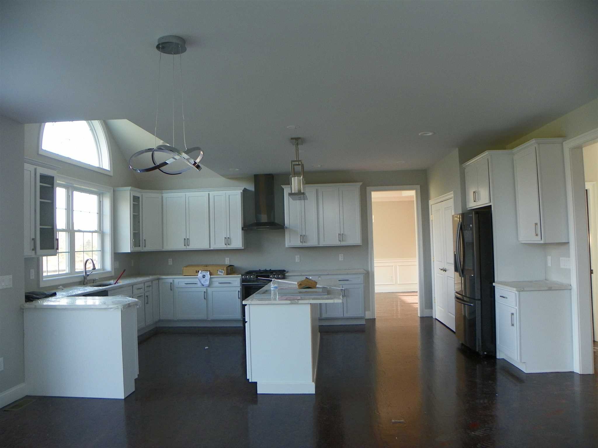 2 Lincoln Square Road Fishkill, NY 12524 - Photo 9 of 18 a kitchen with stainless steel appliances granite countertop a refrigerator a sink a stove and white cabinets with wooden floor
