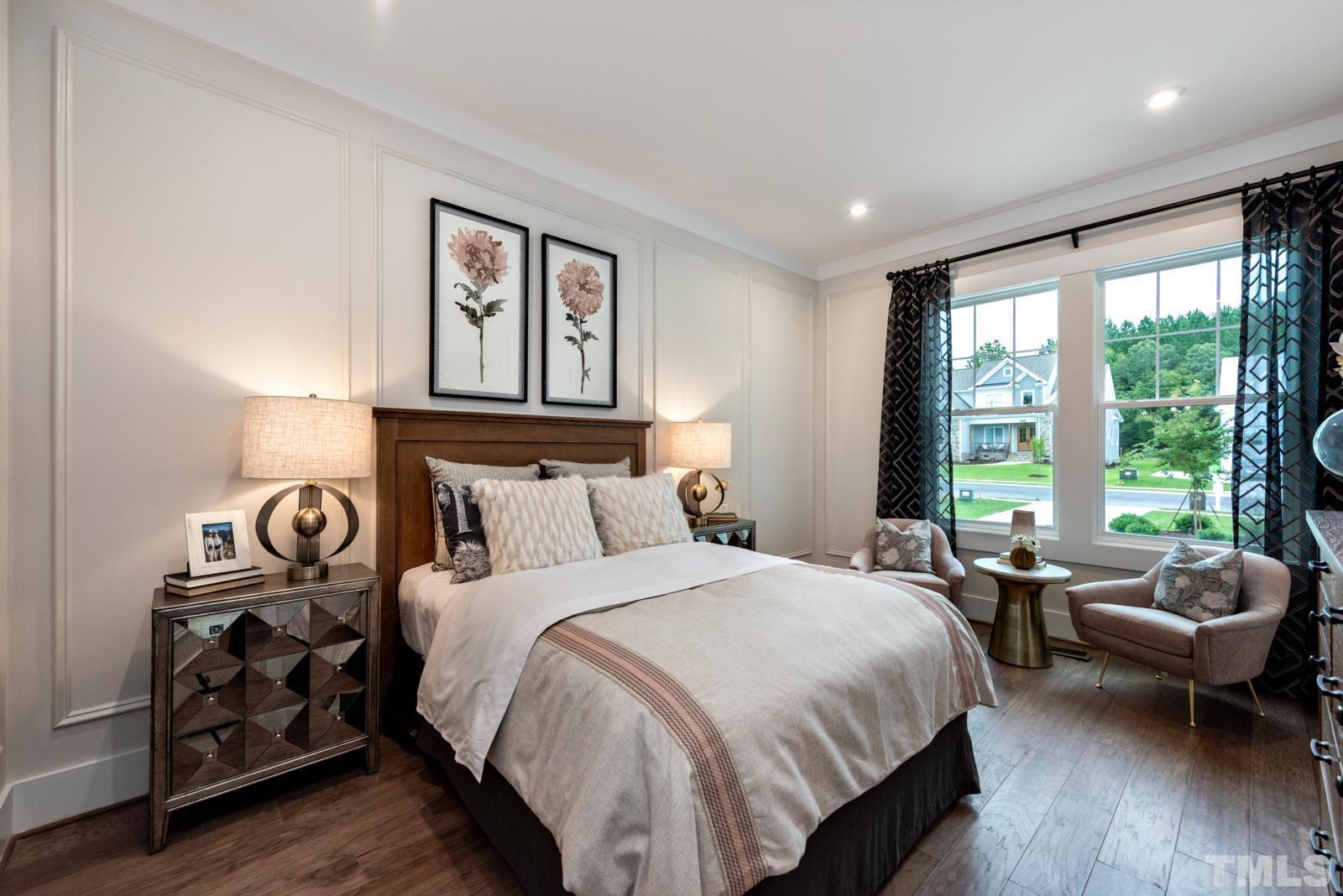 27 E Spring Angier, NC 27501 - Photo 18 of 35 a bedroom with a bed a couch and a large window