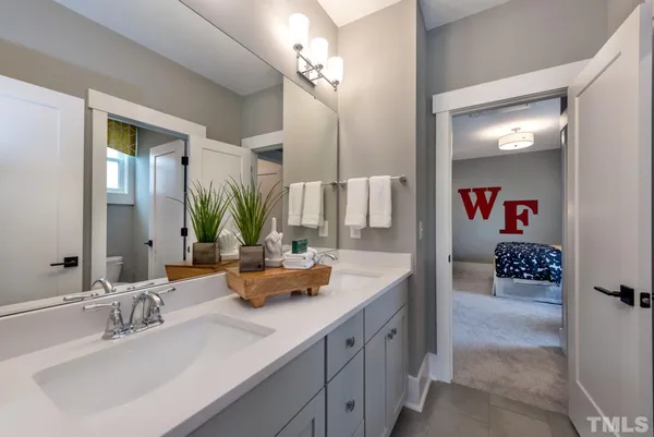 a bathroom with a sink double vanity and a mirror