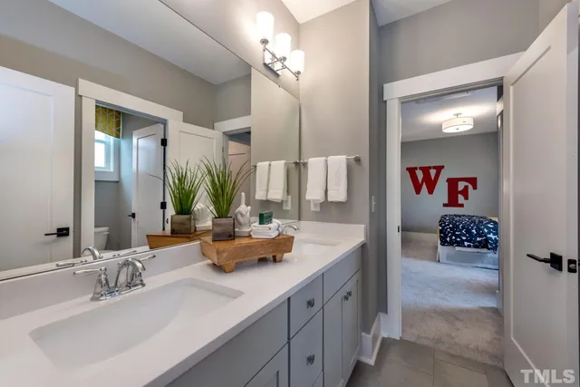 a bathroom with a sink double vanity and a mirror