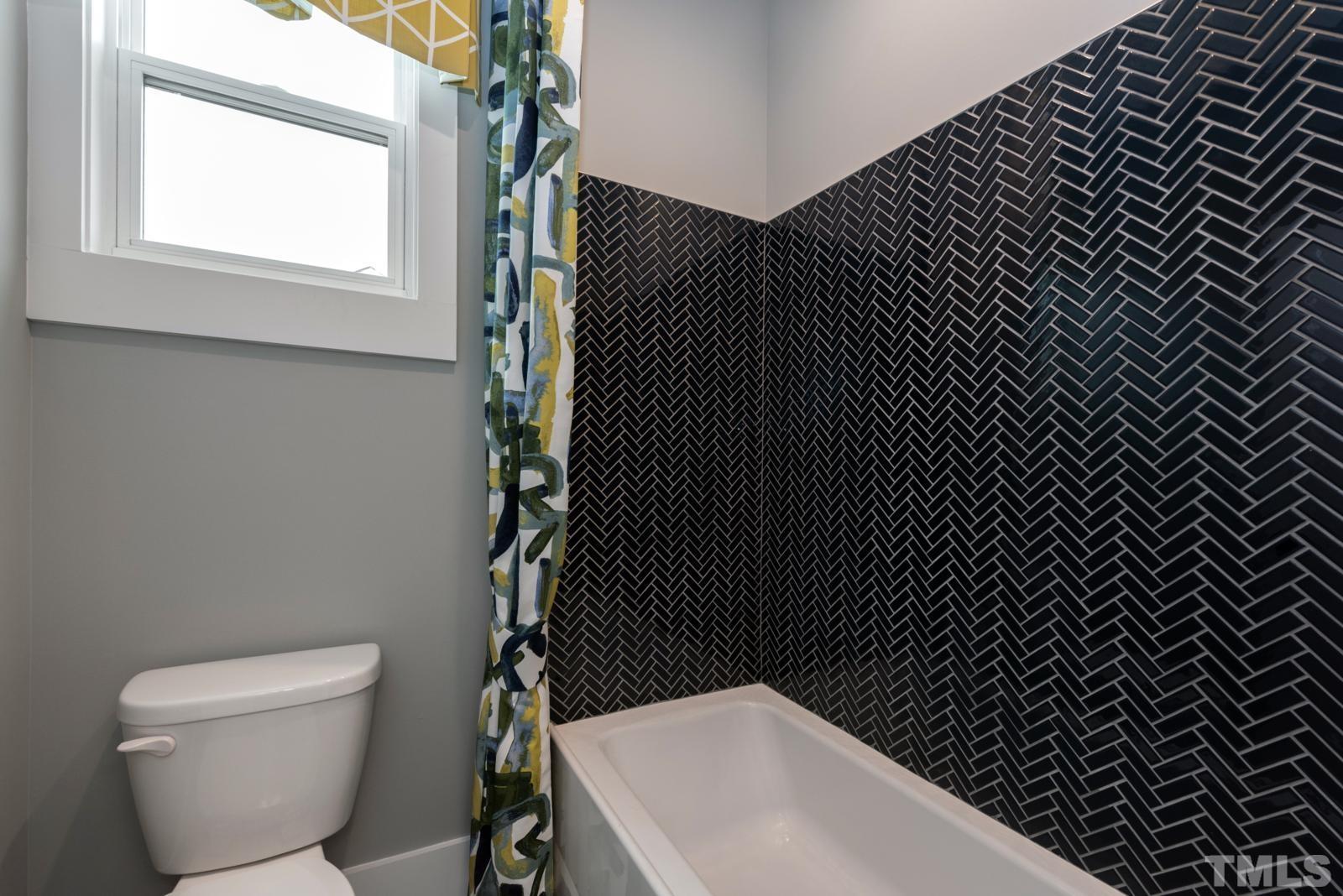 27 E Spring Angier, NC 27501 - Photo 28 of 35 a bathroom with a toilet and a sink