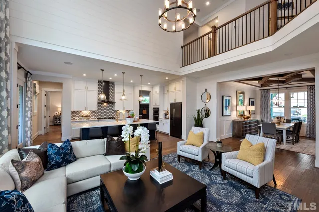 a living room with fireplace furniture and a chandelier