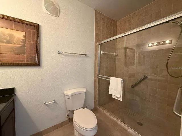 a bathroom with a toilet and a shower