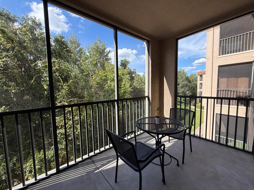 1361 Tuscan Terrace, Unit 7307 Davenport, FL 33896 - Photo 21 of 22 a view of a chairs and table in the balcony