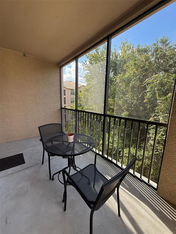 1361 Tuscan Terrace, Unit 7307 Davenport, FL 33896 - Photo 22 of 22 a view of a chairs and table in patio