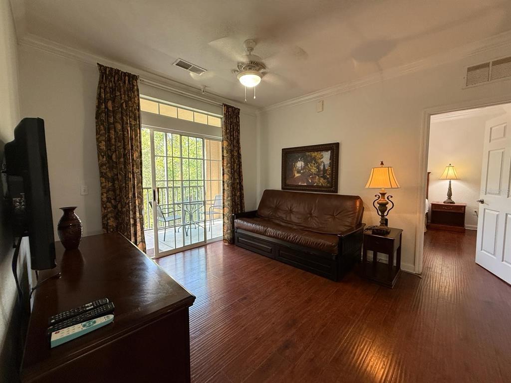 1361 Tuscan Terrace, Unit 7307 Davenport, FL 33896 - Photo 3 of 22 a living room with furniture and a flat screen tv