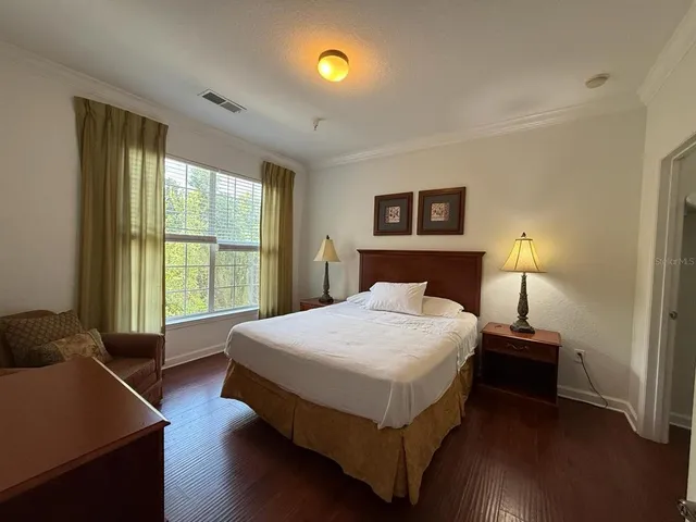 a bedroom with a bed and a lamp