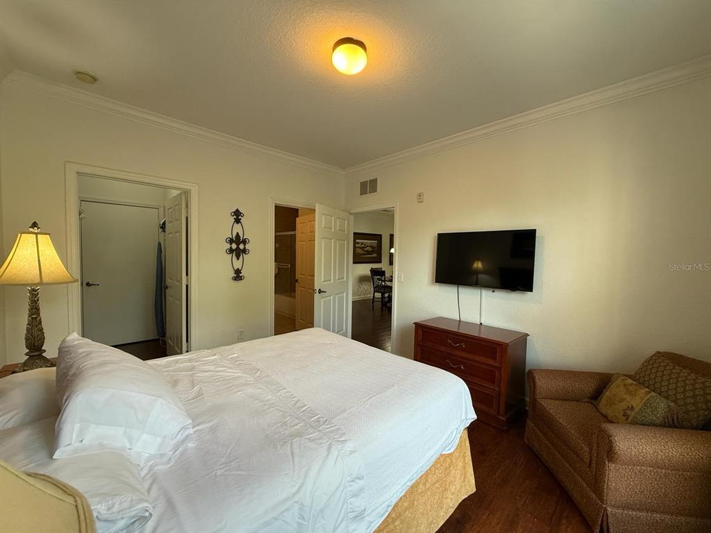 1361 Tuscan Terrace, Unit 7307 Davenport, FL 33896 - Photo 9 of 22 a bedroom with a bed and a flat screen tv