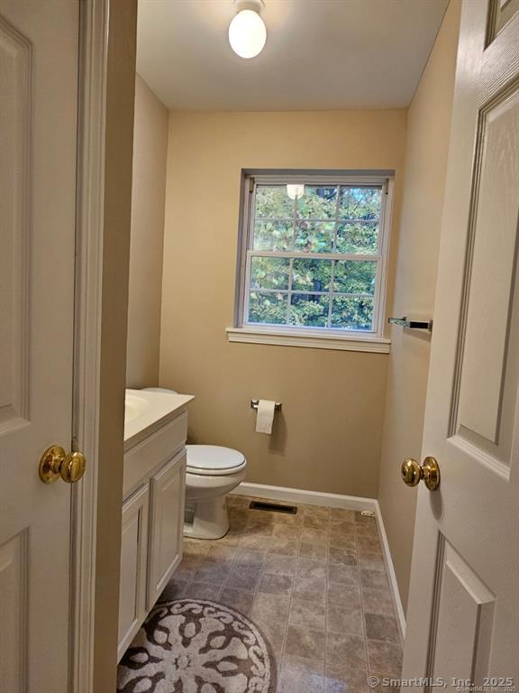 165 Osborn Road Naugatuck, CT 06770 - Photo 15 of 23 a bathroom with a granite countertop sink toilet and a window