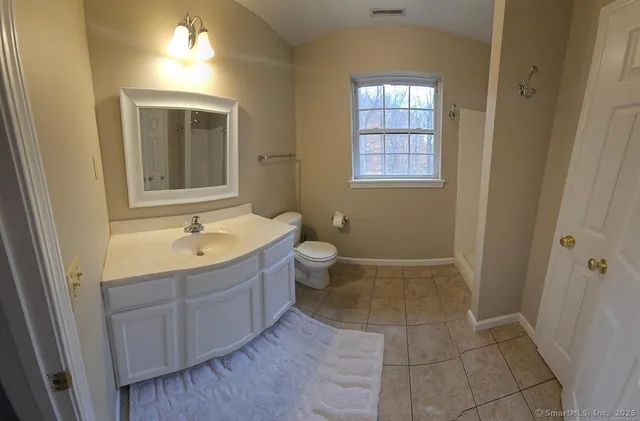a view of bathroom with bathtub toilet and a sink