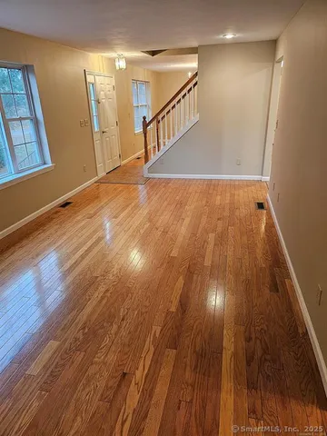 a view of an entryway with wooden floor