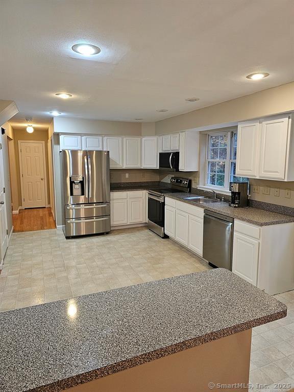 165 Osborn Road Naugatuck, CT 06770 - Photo 8 of 23 a kitchen with granite countertop a sink and stainless steel appliances