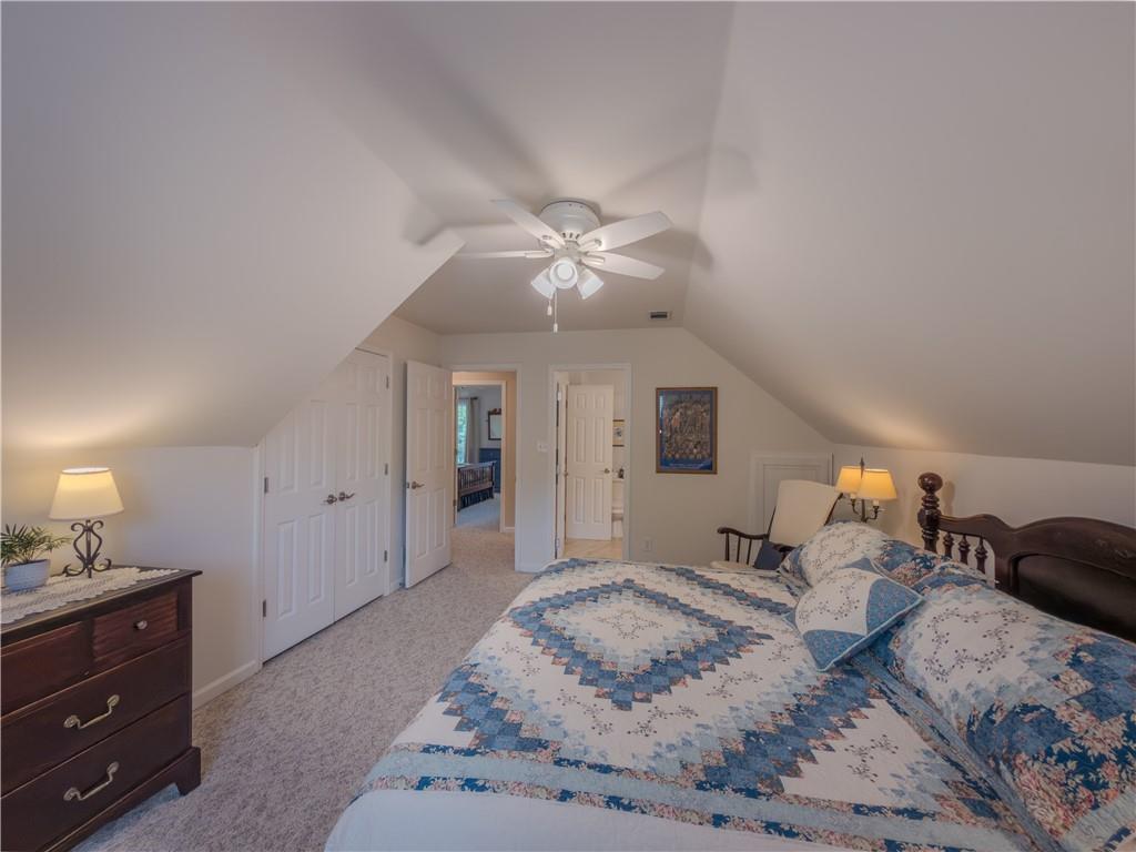 4284 Cedar Bluff Way Southwest Lilburn, GA 30047 - Photo 40 of 62 a spacious bedroom with a bed and a chandelier