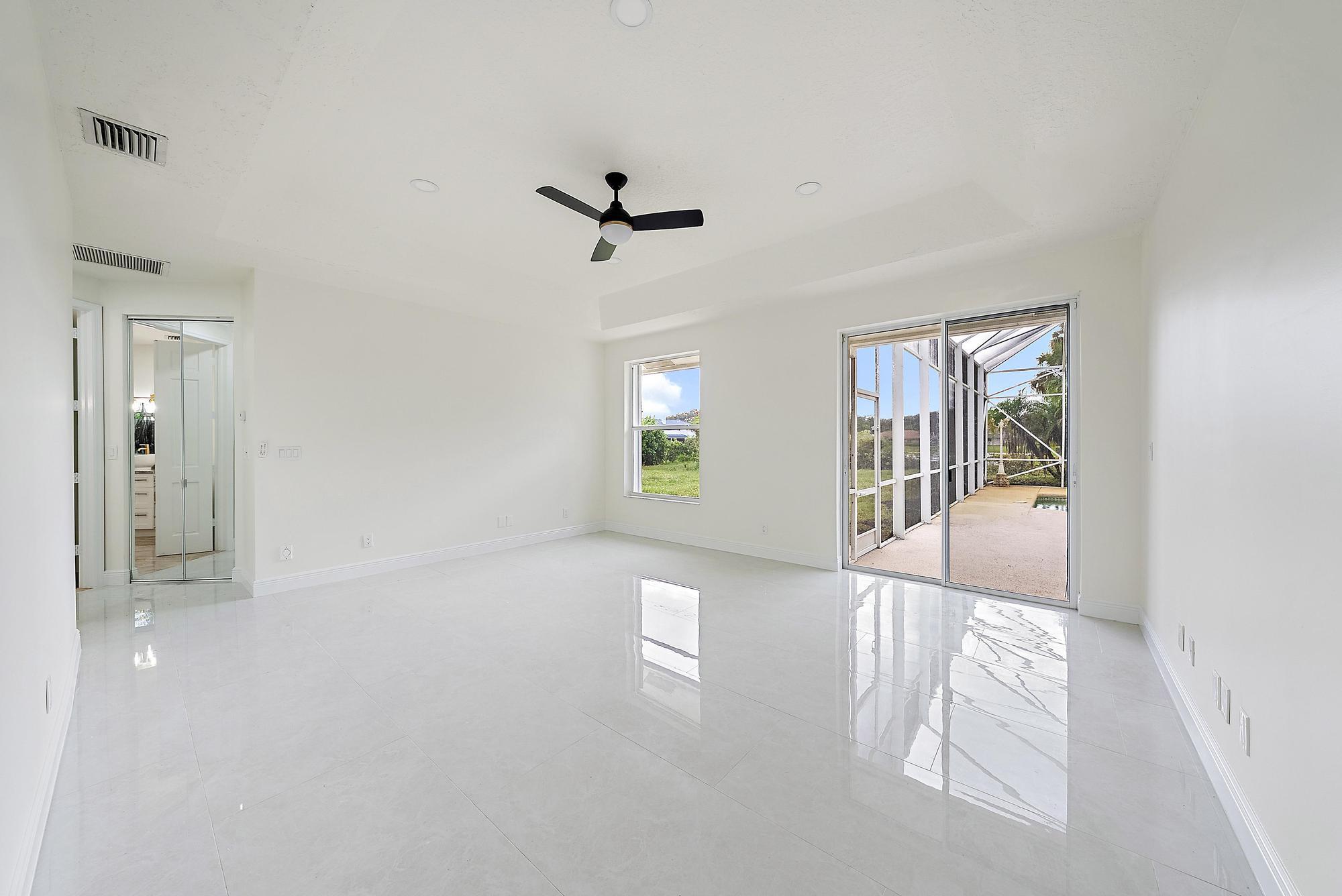19558 Red Gum Trail Jupiter, FL 33458 - Photo 16 of 34 a view of a hallway with windows